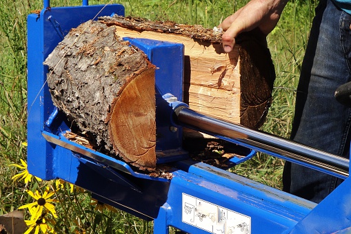 A wood splitter halves firewood.