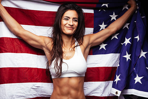 istock Young sportswoman holding American flag 485281156