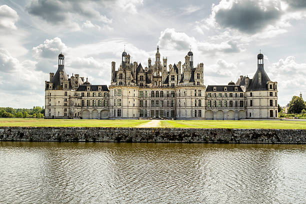 Chambord Castle - Loire - France Chambord, France - August 18, 2015: Panoramic  view of Chambord Castle from the river. Built as a hunting lodge for King Francois I, between 1519 and 1539, this castle is the largest and most frequented of the Loire Valley. blois stock pictures, royalty-free photos & images