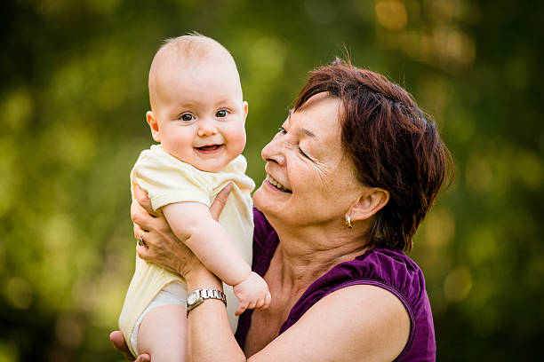 Happy retirement - grandmother with baby stock photo