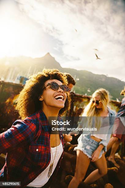 Watching The Seagulls Stock Photo - Download Image Now - Friendship, Laughing, Multiracial Group