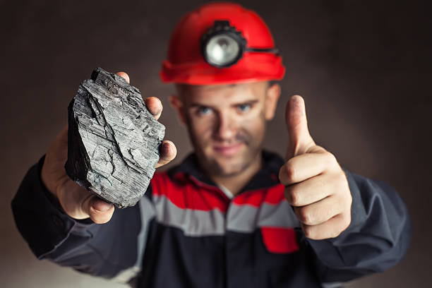 istock miner with lump of coal 485290769