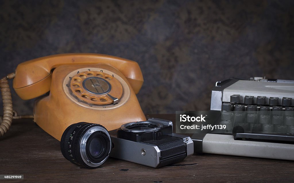 Group of objects on wood table. Group of objects on wood table. old telephone, type writer, old camera, Still life Ancient Stock Photo