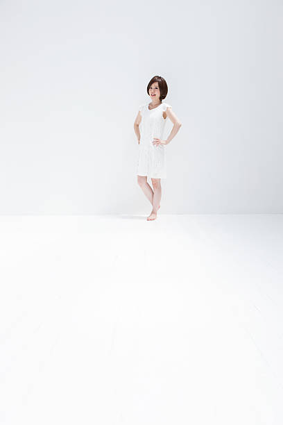 istock Young woman wearing a white dress. 485294055