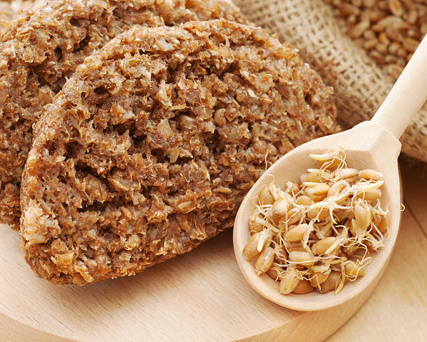 bread from wheat sprouts and sprouted seeds in spoon stock photo