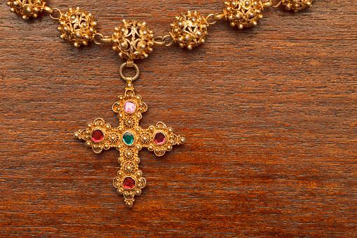 Golden cross with necklace, rosary.