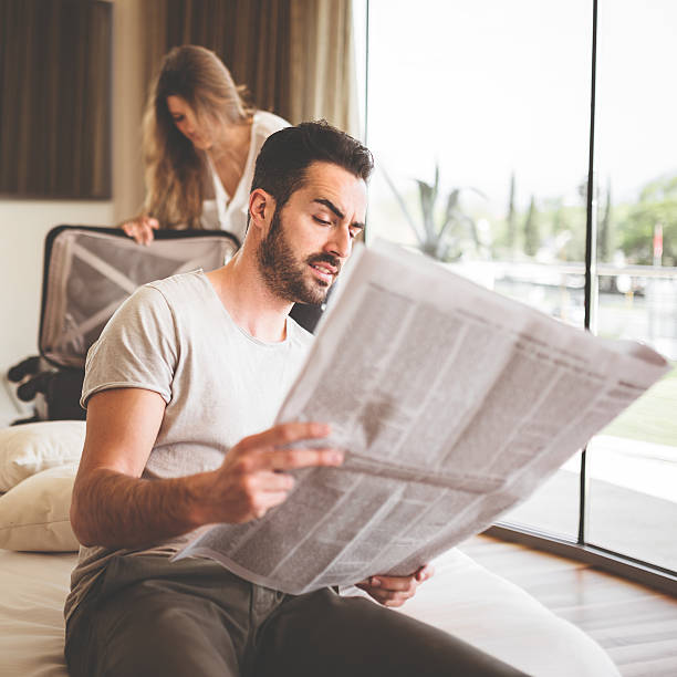 istock man reading the newspaper on bedroom 485296895
