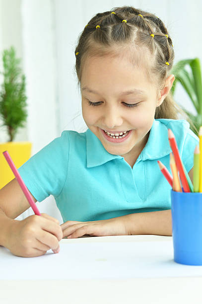 istock Little girl drawing at home 485298638