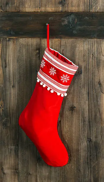 Photo of Christmas stocking. Red sock for Santa gifts. Holidays decoration