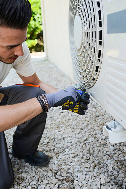 istock handsome young man electrician installing air conditioning in client house 485308424