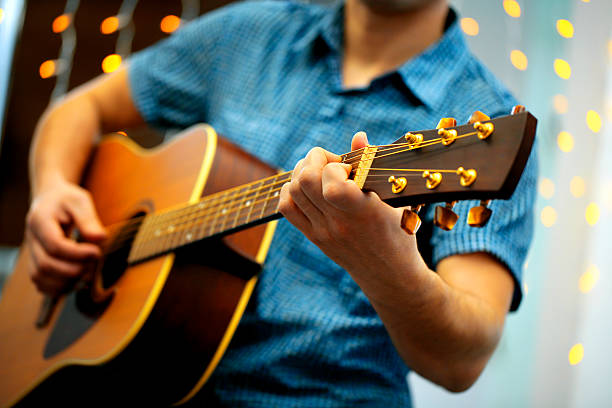 istock Man playing an acoustic guitar during a concert 485308472