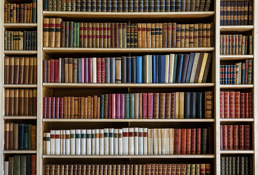 bookcase with many old books in a library