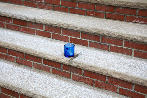 Bright Blue Glass Mug on Brick Steps with Snow