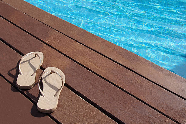 istock Flip flops by the swimming pool 485311015