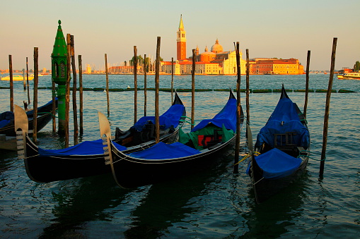Venetian gondolas, San Marco and San Giorgio Maggiore at sunset, Venice