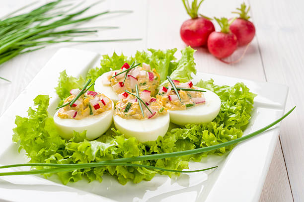 istock Stuffed eggs on lettuce with chives garnish 485311427
