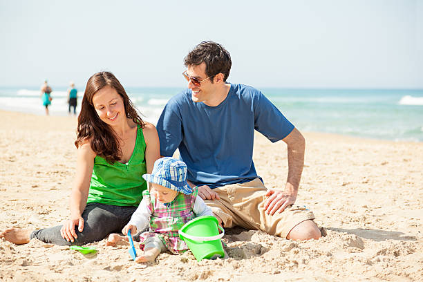 istock Happy young family on beach 485312133