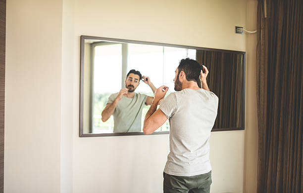 istock combing the hair in front of mirror 485312311