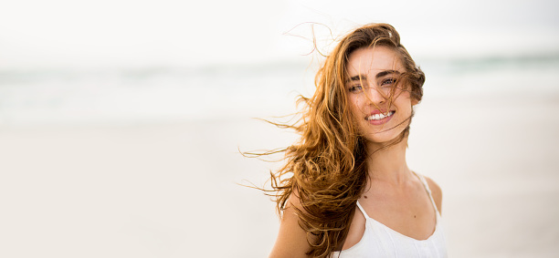 Smiling girl at beach with copy space