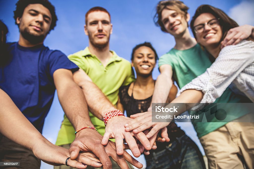 Young adults cooperating together Young adults cooperating together, unity concept. Achievement Stock Photo