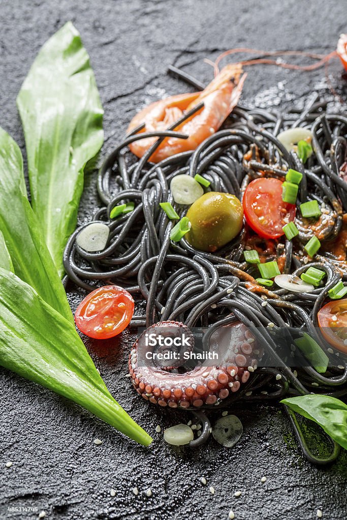 Spaghetti made from black pasta and prawn Spaghetti made from black pasta and prawn. Basil Stock Photo