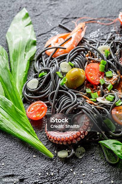 Spaghetti Made From Black Pasta And Prawn Stock Photo - Download Image Now - Basil, Bolognese Sauce, Cherry Tomato