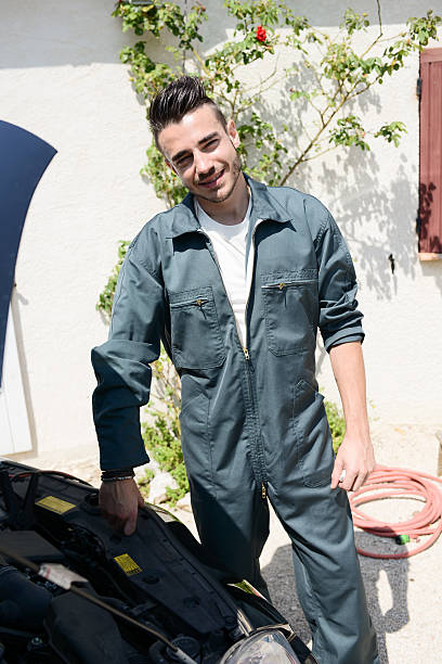 istock handsome young man car mechanic checking car engine breakdown outdoor 485315058