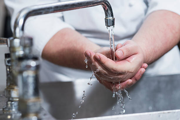 istock Worker in restaurant washing hands in kitchen sink 485317426