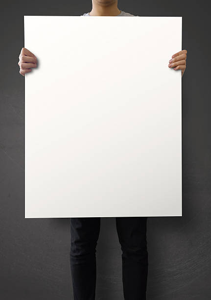 istock hipster holding blank poster on texture wall as concept 485317531