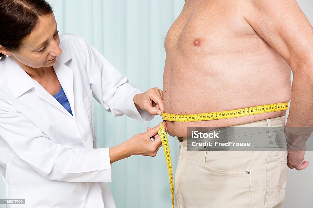 Overweight senior adult Medical examination: doctor measures overweight Measuring Stock Photo
