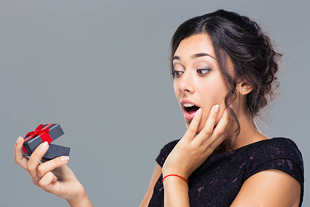istock Amazed woman holding gift box 485317866
