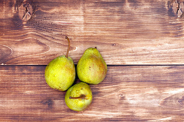 istock Pears on wooden background top view 485321086