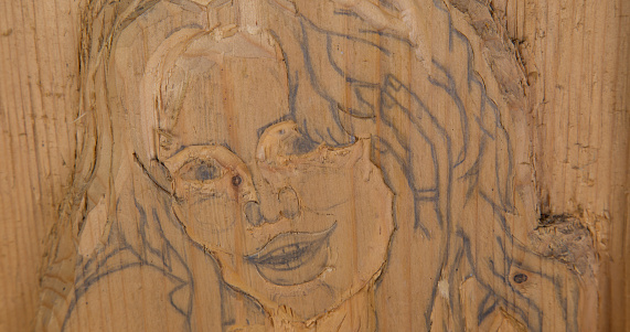 Girl portrait carved in wood