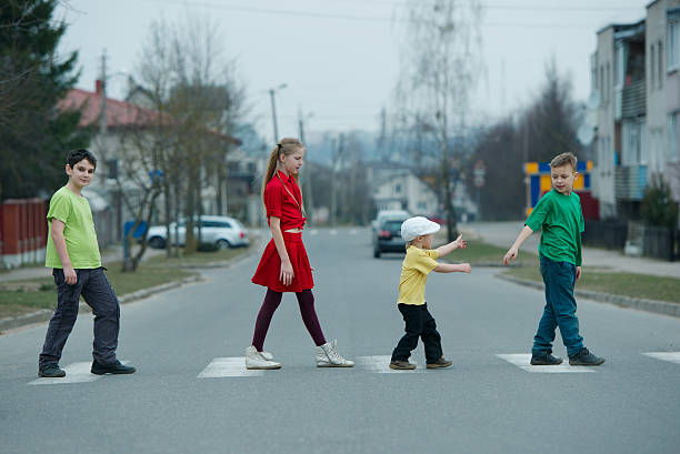istock children crossing street on crosswalk 485322916