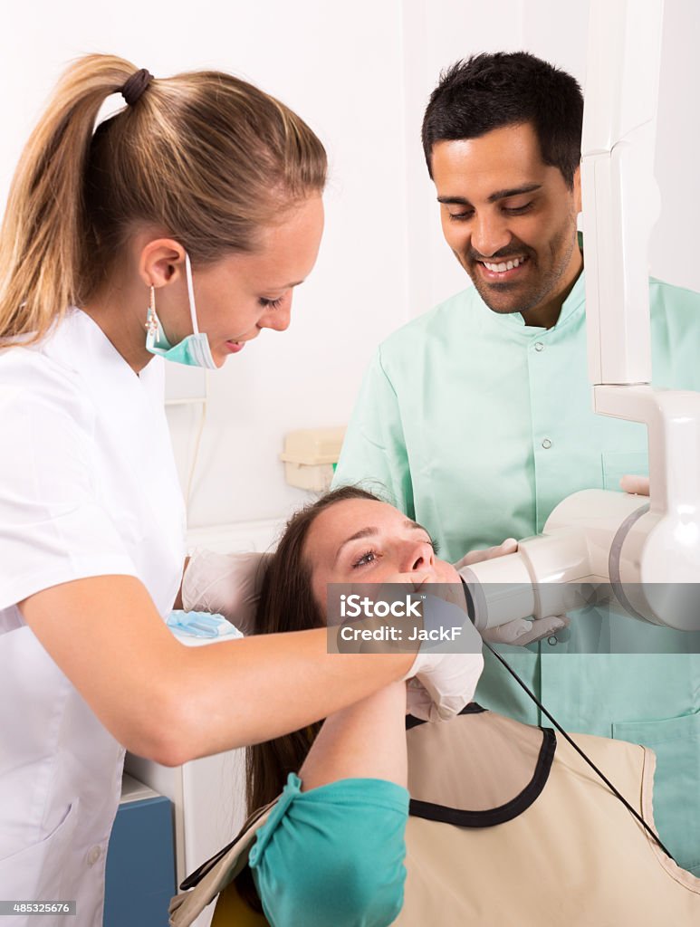 Portrait of doctor and positive patient Portrait of doctor and positive patient at dental clinic 2015 Stock Photo