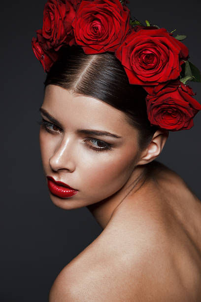 istock young brunette with roses on head and red lipstick 485326614