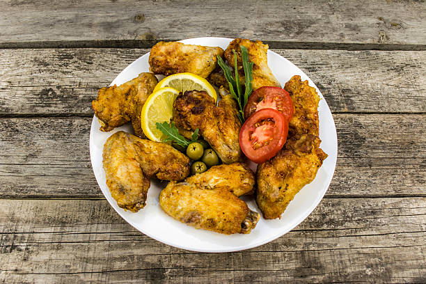 istock chicken wings with tomato and lemon 485329286