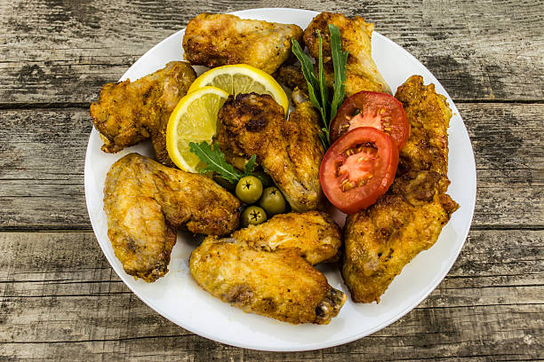 istock chicken wings with tomato and lemon 485329290