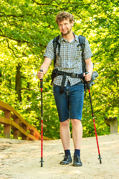 istock young man with backpack hiking in forest trail 485330666