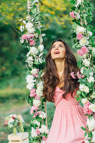 istock Beautiful young girl on a swing 485330778