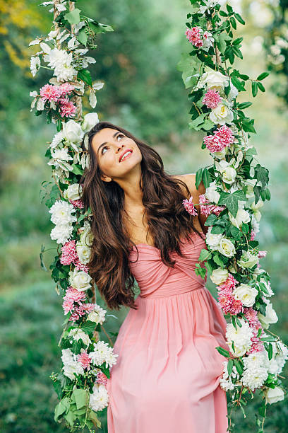 istock Beautiful young girl on a swing 485330786