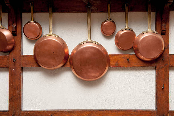 istock Vintage copper pans hung on wooden shelf 485331012