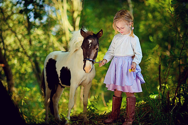 istock Girl and pony 485331032