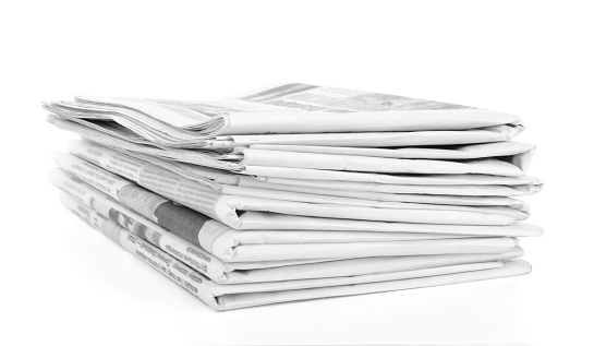 Newspapers stack isolated on white background.