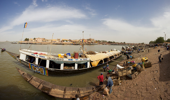 Mopti, Mali - December 31, 2010: Unidentified people packing parcels near by a vessel at the harbor on the Niger River in Mali 2012.