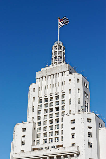 The famous skyscraper from São Paulo, the 'Edifício Altino Arantes' known as Edifício Banespa, in a closer view  of the top with the state of São Paulo flag.