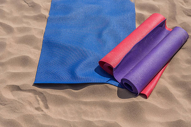 istock Yoga mats thrown on the beach - preparing for the lesson 485332858
