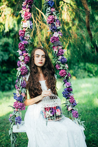 istock Beautiful young girl on a swing 485332986