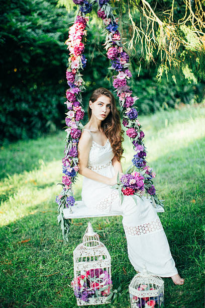 istock Beautiful young girl on a swing 485333062