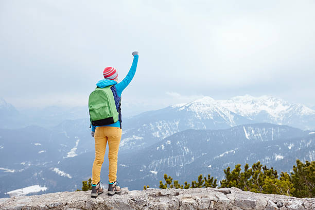 istock Girl with raised hand in mountains 485334762